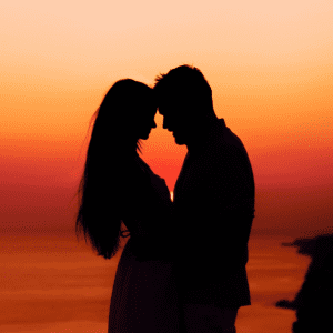 a romantic couple enjoying a beach on Koh Tao at sunset